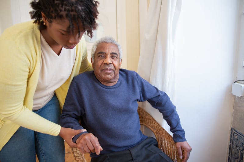 A caregiver providing personal attention to a resident in the home-like setting at TrueNest